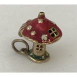 A 9ct gold and enamelled mushroom charm. Top opens to reveal a pixie.