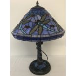 A tiffany style table lamp with leaded glass shade and lamp base.