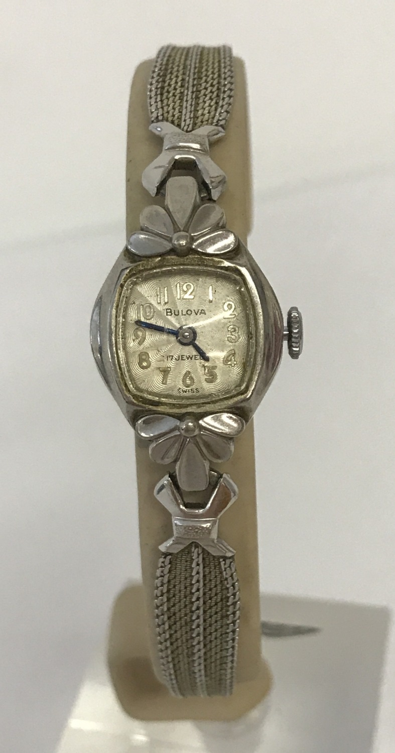 A ladies vintage 10k rolled gold plate wristwatch by Bulova. Floral decoration to case.