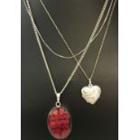 3 silver necklaces. Comprising: pressed flower pendant on a fine curb chain, a heart shaped locket
