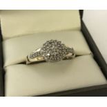 A 9ct gold and diamond cluster ring. Diamonds total approx .25ct.