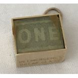 A 9ct gold box charm containing a one pound note. Base marked "Break In Emergency".