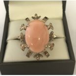 A large vintage coral set cocktail ring. Decorative mount with flower and leaf detail.