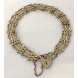 A 9ct gold 4 bar bracelet with padlock clasp and safety chain.
