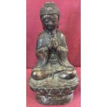 A hollow bronze figure of Buddha with gilt detail.