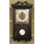A modern dark wood cased, 31 day wall hanging pendulum clock.