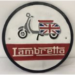 A cast metal circular shaped wall hanging Lambretta plaque with scooter motif.
