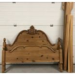 A modern double solid wood pine bed frame with carved detail to headboard.