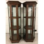 A pair of Edwardian hexagonal shaped dark wood framed glass display cabinets.