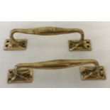 A pair of antique brass door handles.