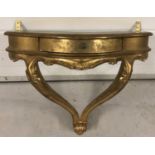 A vintage style gilt wall mounted table/shelf with central drawer.