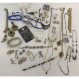 A tub of modern and vintage diamante and stone set costume jewellery.