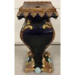 A Victorian majolica glazed Jardinière stand with leaf and scallop shell design (a/f).