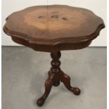 A reproduction inlaid occasional table raised on tripod feet, with floral design to top