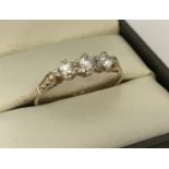 A 9ct gold cubic zirconia stone set trilogy ring.