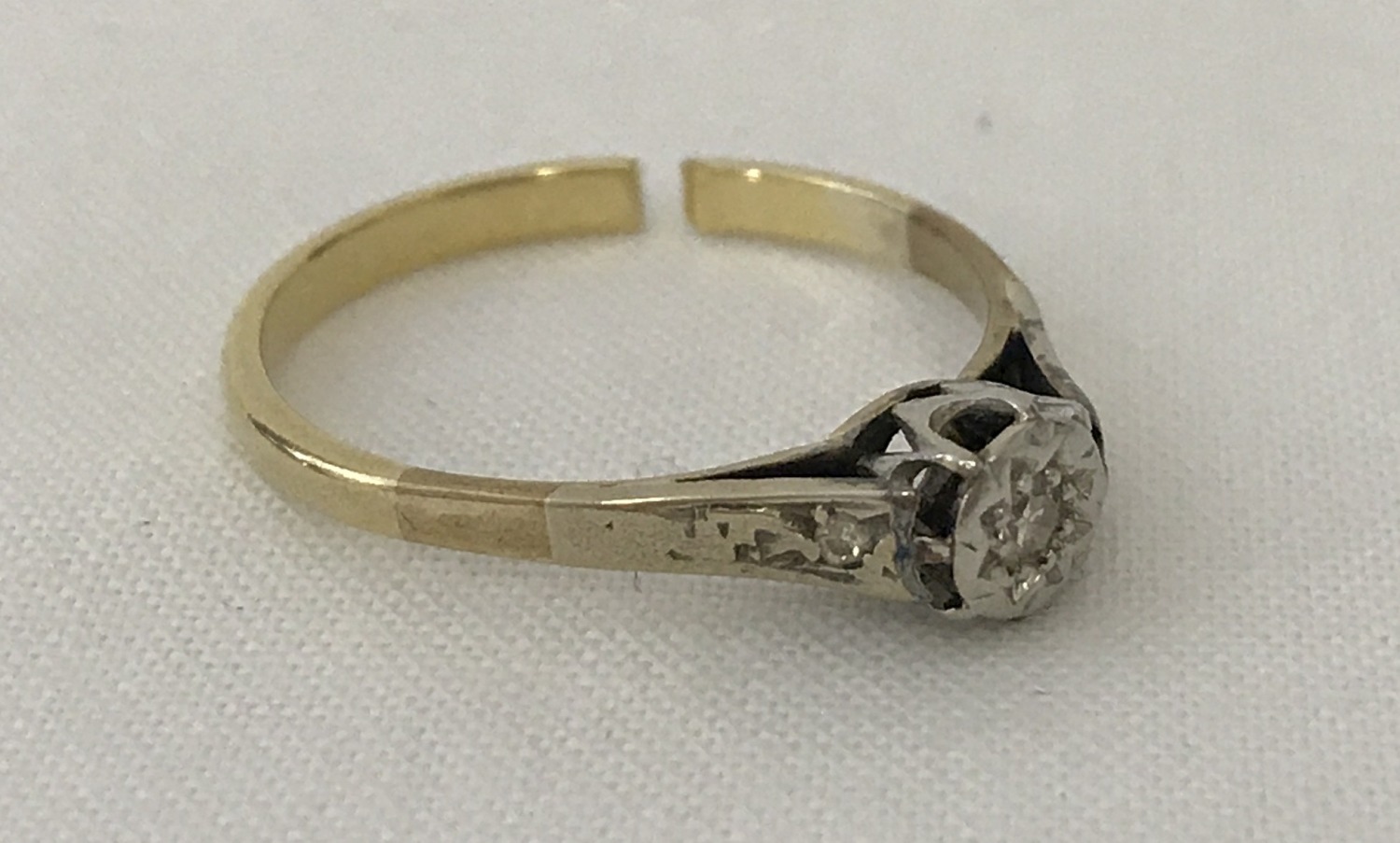 A vintage scrap gold illusion set diamond solitaire ring.