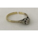 A vintage scrap gold illusion set diamond solitaire ring.