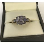 A 9ct gold and amethyst and diamond dress ring.