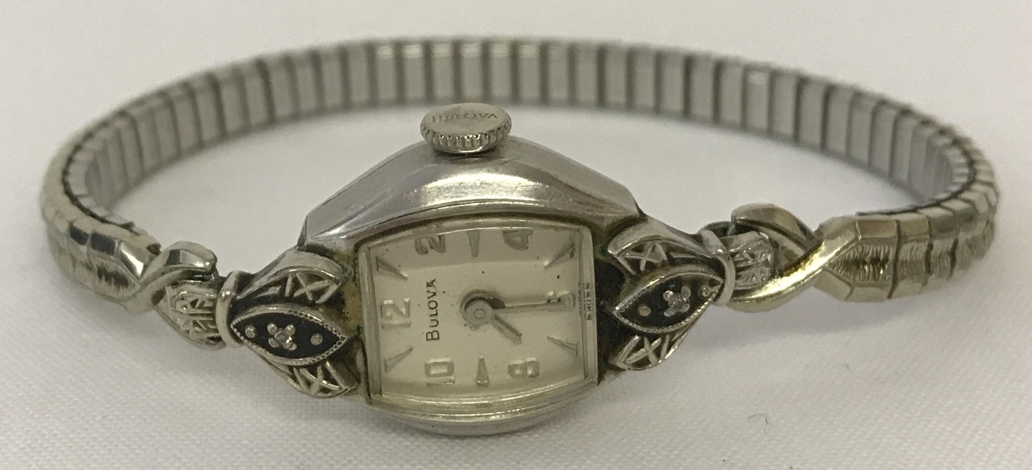 A ladies vintage white 10k rolled gold plate and diamond wristwatch by Bulova.