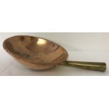 A heavy antique copper and brass dome based candy pan.