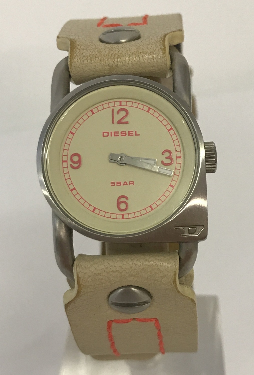 A ladies modern wristwatch by Diesel with cream leather strap with neon orange stitching.