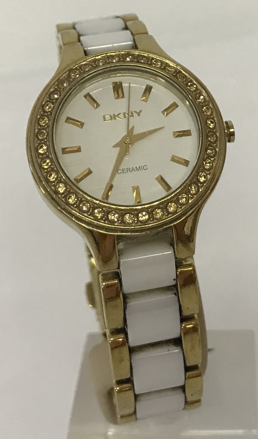 A ladies modern gold tone stainless steel and ceramic strap wristwatch by DKNY.