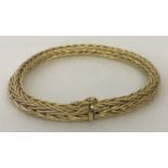 A 9ct gold bracelet with plaited wheat style chain and push clasp and safety clip.