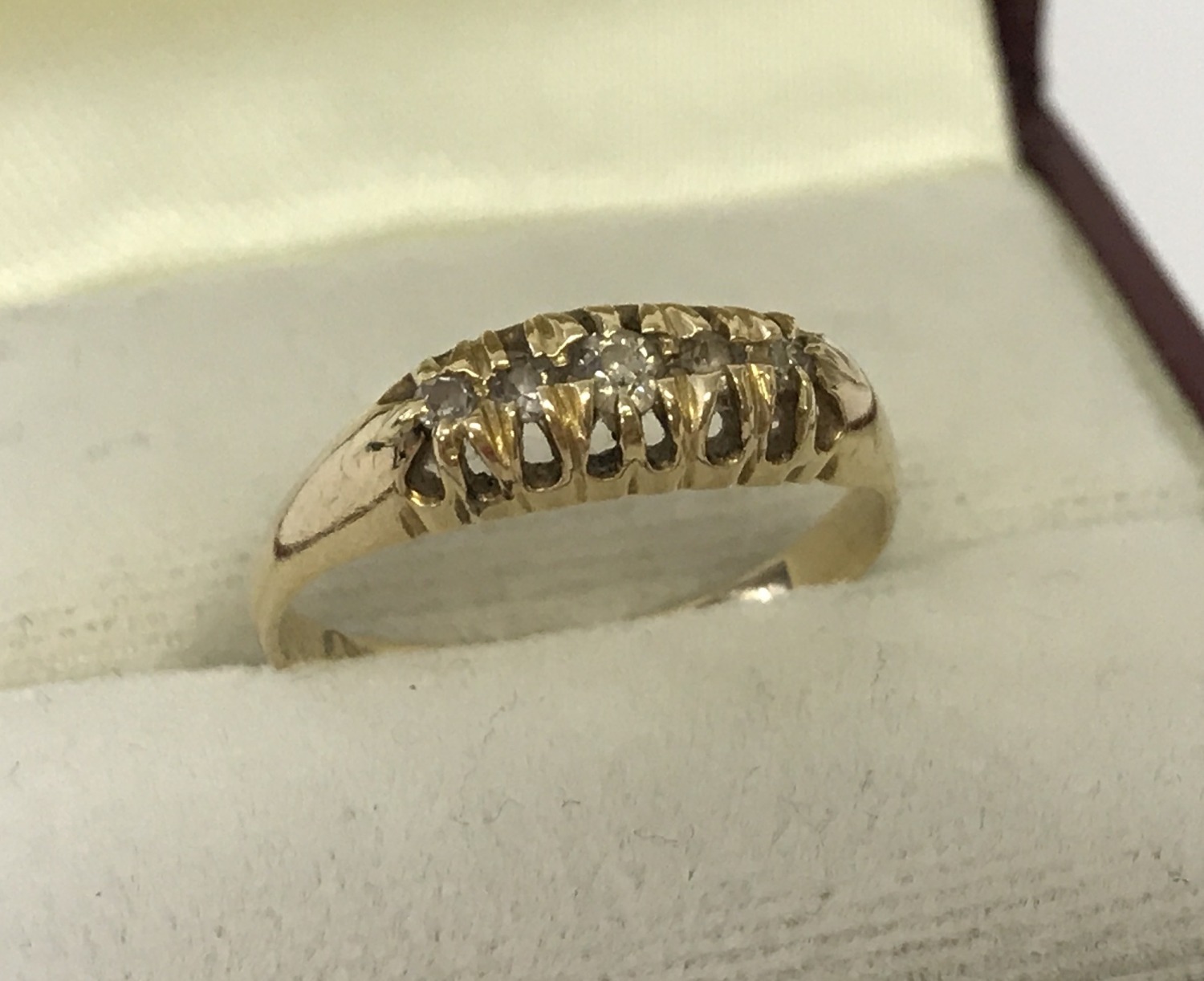 A vintage 18ct gold diamond set gypsy style ring. 5 round cut diamonds set to top.