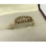 A vintage 18ct gold diamond set gypsy style ring. 5 round cut diamonds set to top.