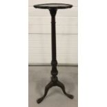 A Victorian rosewood torchere with decoratively carved pedestal raised on tripod feet.