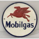 A circular shaped cast iron Mobilgas wall hanging plaque.