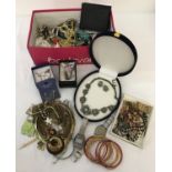 A box of mixed costume jewellery and watches.