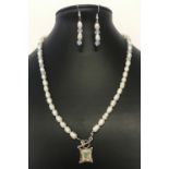 A modern design potato pearl and clouded glass bead necklace and matching drop style earrings.