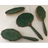 An Art Deco 4 piece green guilloche decorated dressing table set.