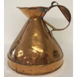 A Georgian copper 1 gallon haystack ale jug with leaded GR stamp and unusual handle.