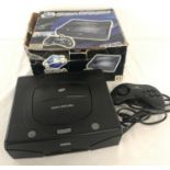 A 1990's boxed Sega Saturn console complete with wired controller.
