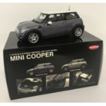 A brand new boxed, 1:18 scale, Mini Cooper by Kyosho.
