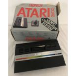 A boxed 1980's Atari 2600 console, no power lead or joy stick.