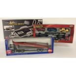 3 boxed diecast car trailers and transporters, 1 complete with cars.