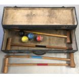 A vintage wooden cased part croquet set; comprising 4 mallets and 4 coloured balls.