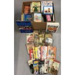A box of assorted children's books and games.