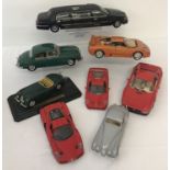 A box containing 8 larger scale diecast vehicles to include Maisto, Burago and Sun Star.