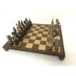 A large Romans v Vikings resin Chess board and pieces.