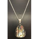 An abalone shell and silver pendant on a 24" curb chain.