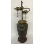 A vintage metal lamp base with cloisonné detail. Twin bulb fitment with pull style switches.