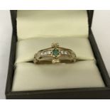 A vintage 9ct gold dress ring set with an emerald and diamonds.