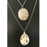 A vintage white metal oval locket with engraved bird & floral decoration, on a silver curb chain.