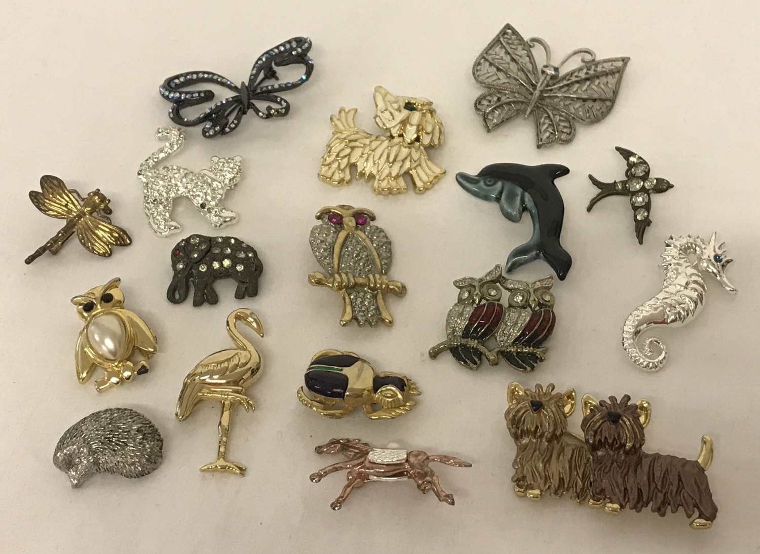 A collection of vintage and modern animal and insect design brooches.