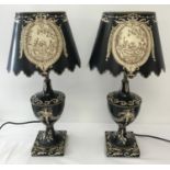 A pair of black tole ware table lamps of classical design with hand painted matching metal shades.