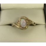 A 9ct gold dress ring set with an oval cut cabochon opal. Twist style decorative mount.